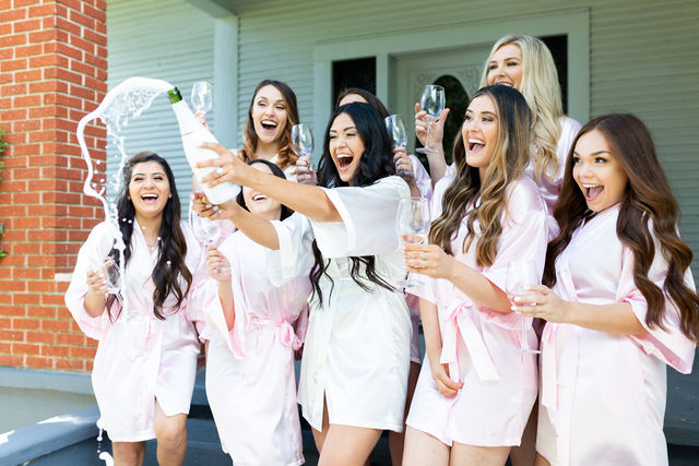 wedding party popping champagne